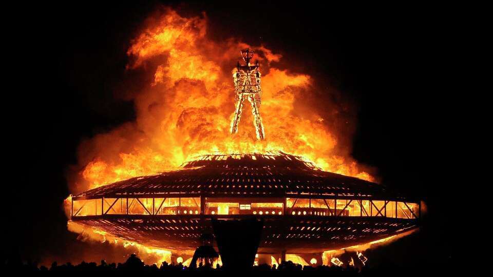 FILE - In this Aug. 31, 2013 file photo, the 'Man' burns on the Black Rock Desert at Burning Man near Gerlach, Nev. Burning Man organizers sued the U.S. Bureau of Land Management to recover millions of dollars they say the government has overcharged them in fees over the past seven years at the counter-culture celebration in the Nevada desert. Black Rock City LLC, the nonprofit that produces the annual Burning Man event, filed the lawsuit Dec. 13, 2019 in U.S. District Court in Washington.