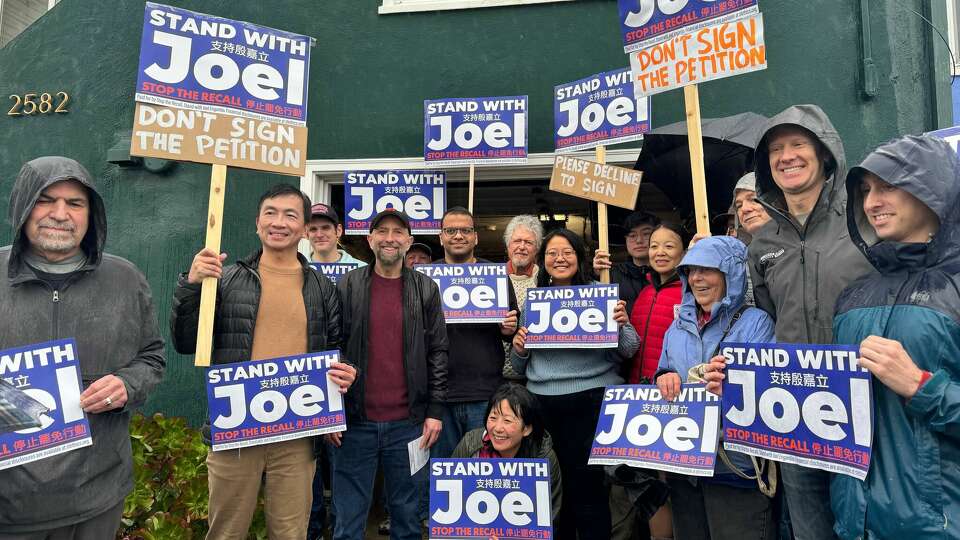 San Francisco Supervisor Joel Engardio, fourth from left, and his supporters rally against the recall drive Saturday. 