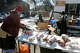 Barbara Dublin, right, distributes food items at Greater Waterbury Interfaith Ministries’ food pantry, in Waterbury, Conn. Jan. 28, 2025.