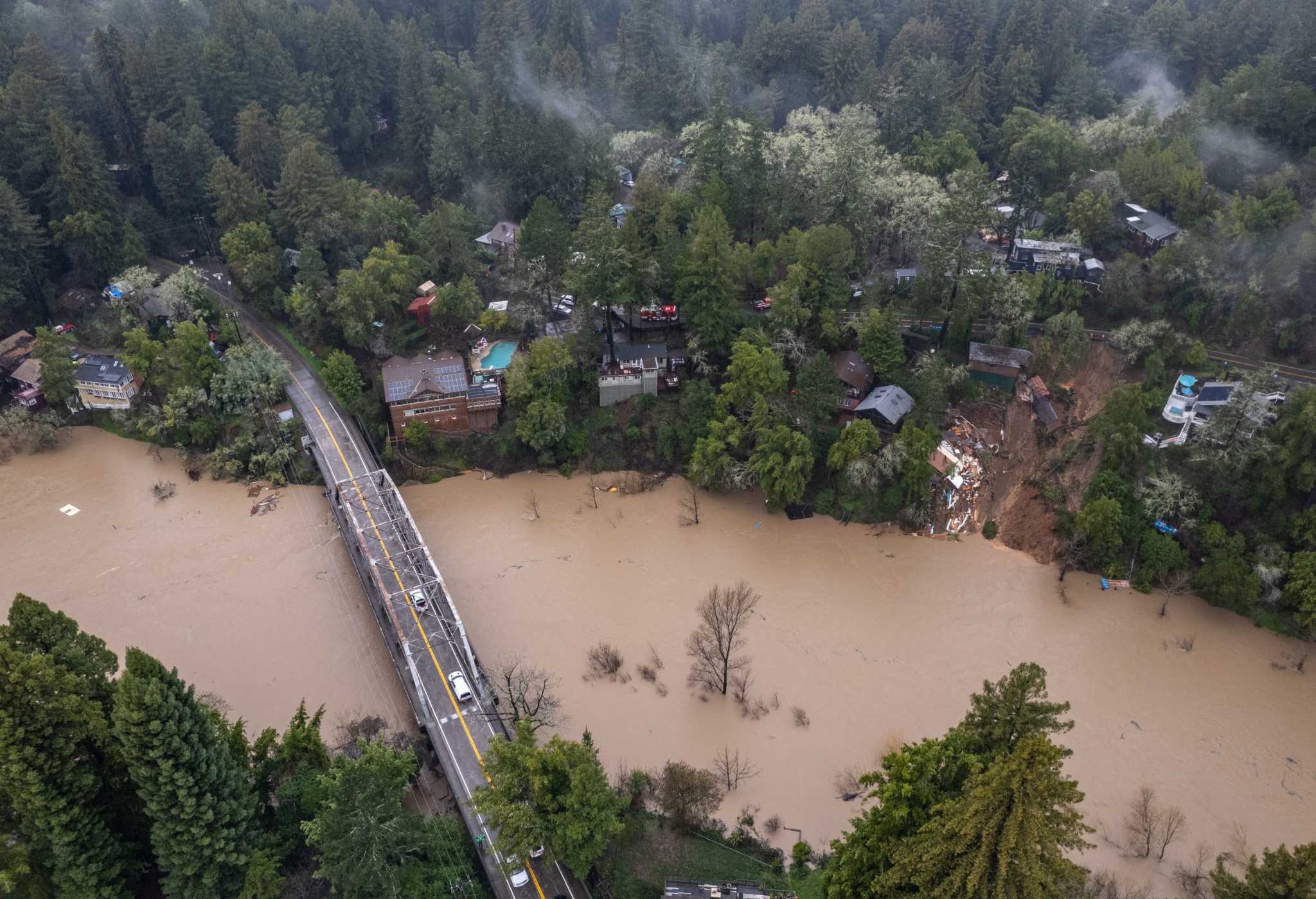 Dramatic photos show home that slid into Russian River as storms raged