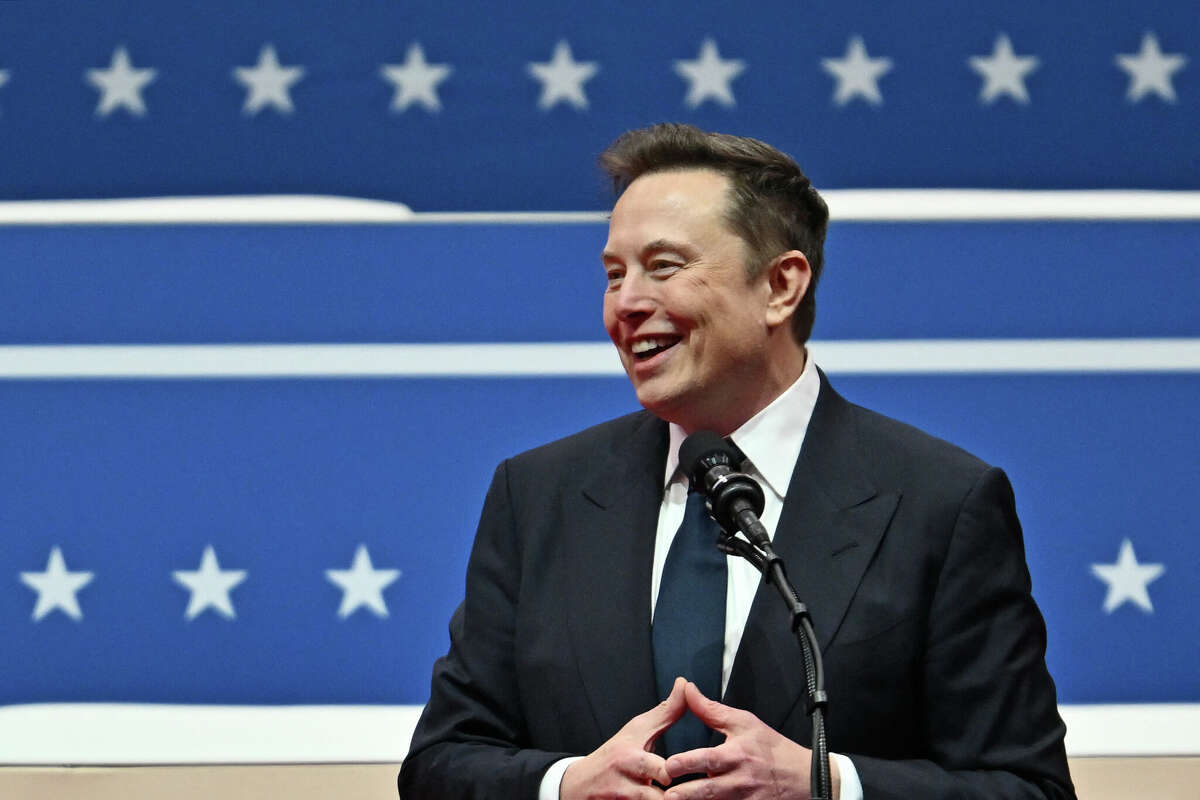 Tesla and SpaceX CEO Elon Musk gestures as he speaks during the inaugural parade inside Capital One Arena, in Washington, DC, on January 20, 2025.