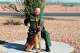 This undated and unknown location photo released by the Department of Homeland Security shows Border Patrol Agent David Maland posing with a service dog.