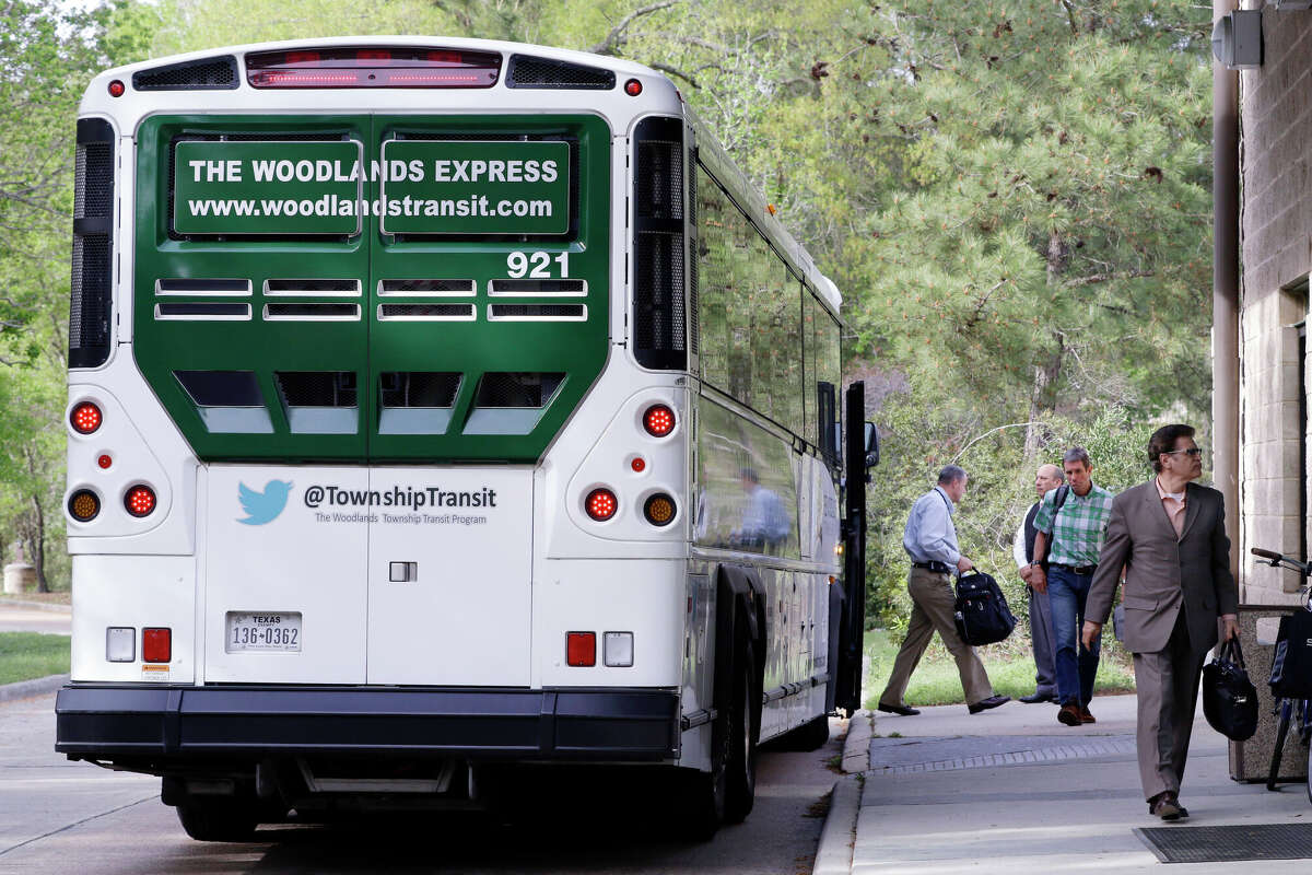 Communters exit one of the buses of The Woodlands Express, a commuter bus service to Houston, at the Marisco Place 'Park and Ride' location in The Woodlands, TX, Monday, March 19, 2018. (Michael Wyke / For the Chronicle)