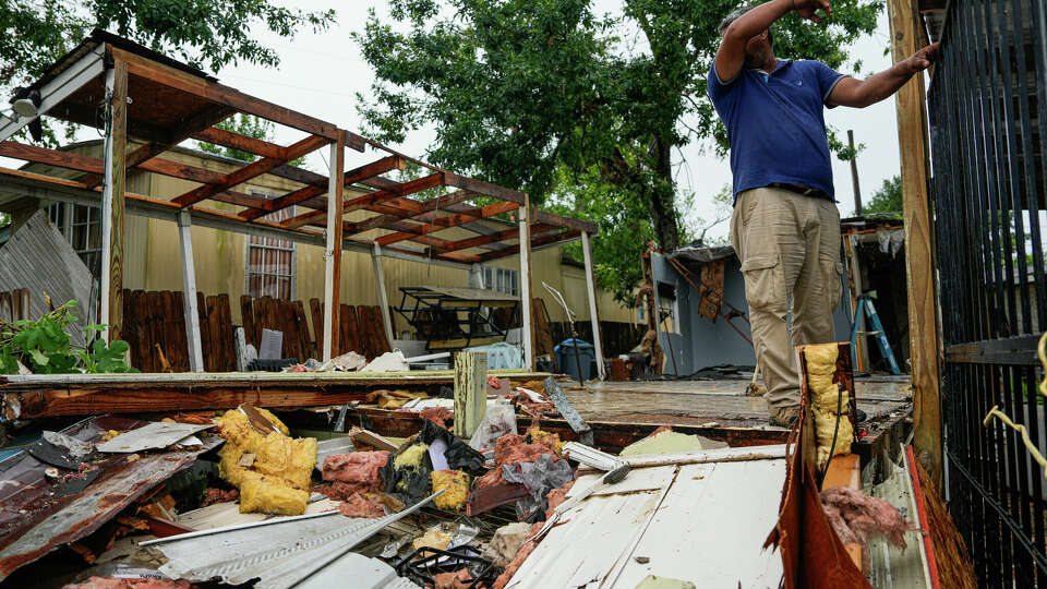 Gabriel Gomez, 46, helps clean up a homes within the West Houston Mobile Home Community that was recently destroyed by Hurricane Beryl on Thursday, July 18, 2024 in Houston. This community had also been hit hard by the previous storm, El Derecho, leaving many with not enough time to prepare for Hurricane Beryl.