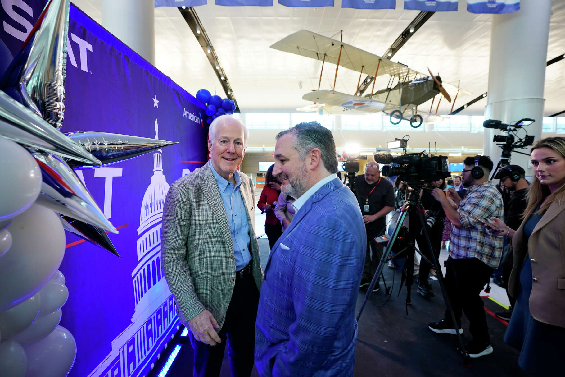 Senators John Cornyn and Ted Cruz chat during a ceremony Sunday celebrating the inaugural, direct flight from the San Anttonio International Airpoirt to Washington D.C.'s Reagan National. The flights will be seven days per week.