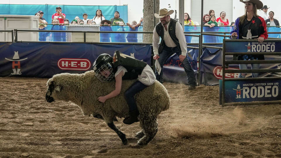 Colette Harrison, 5, tries mutton bustin' for the first time at the Houston Livestock Show and Rodeo on Tuesday March 7, 2023 in Houston.