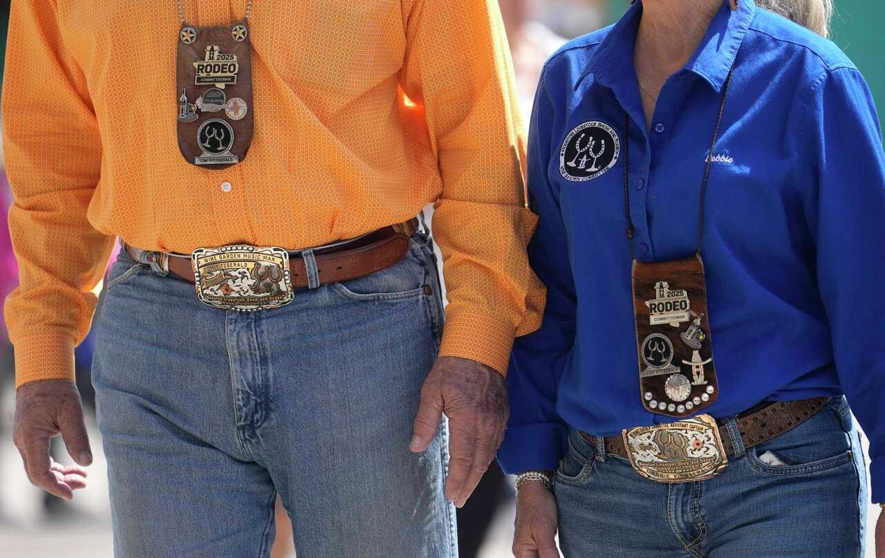 Volunteers wear their gold badges at the Houston Livestock Show and Rodeo in Houston, Wednesday, March 12, 2025.