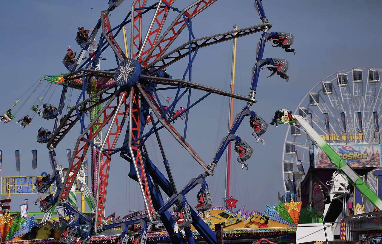 Ride goers take to the air at the Houston Livestock Show and Rodeo grounds in Houston on Thursday, March 13, 2025.