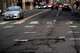 Cars drive along W Burnside Street as cracks are seen in the road on Thursday, Feb. 6, 2025, in Portland, Ore.