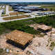 Workers construct homes near Cleveland ISD's Santa Fe Elementary School in the Colony Ridge subdivision about 45 minutes northeast of Houston, Tuesday, Aug. 20, 2024, in Cleveland.