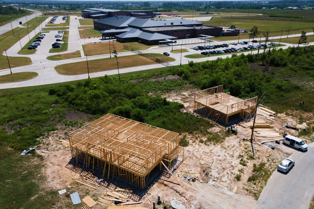 Workers continue progress on framing homes which boarder Cleveland ISD?s Santa Fe Elementary School in the Colony Ridge subdivision about 45 minutes northeast of Houston, Tuesday, Aug. 20, 2024, in Cleveland.