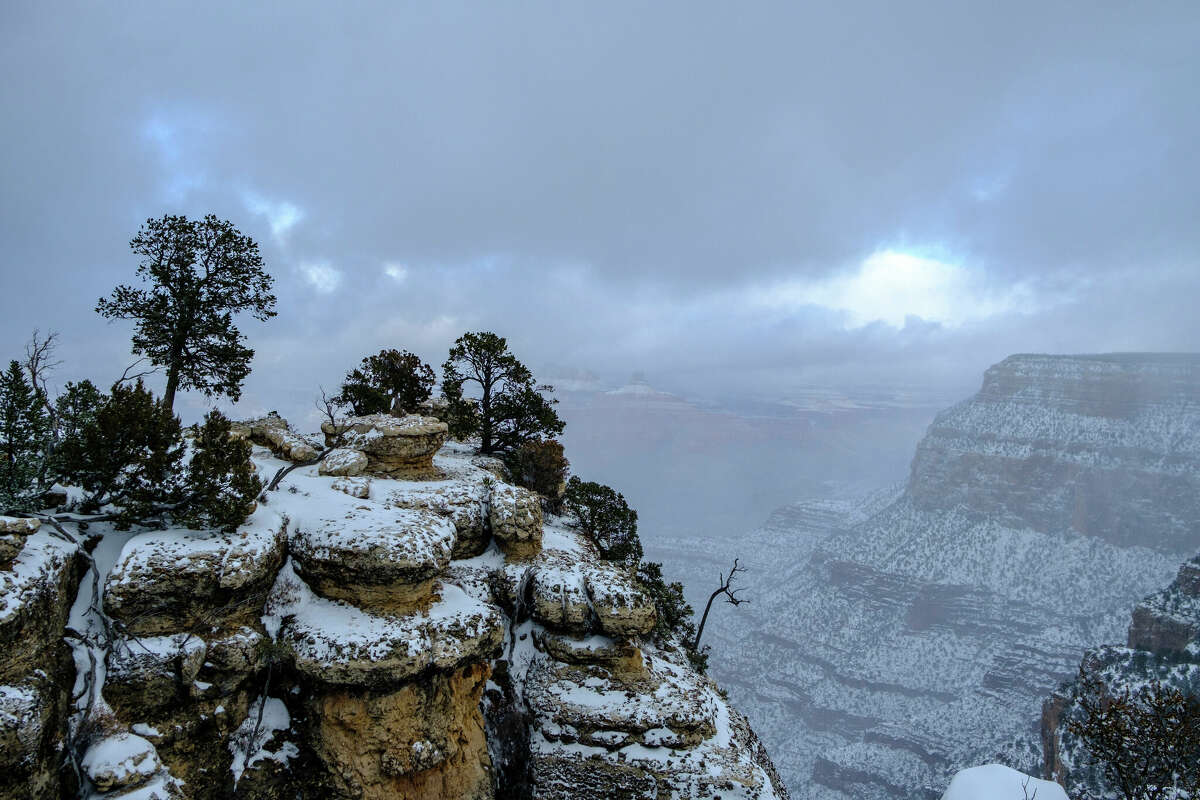 THE GRAND CANYON, ARIZONA, UNITED STATES - 2024/01/08: View of snow on the cliffs of The Grand Canyon taken along the southern rim of the canyon following a snow storm.