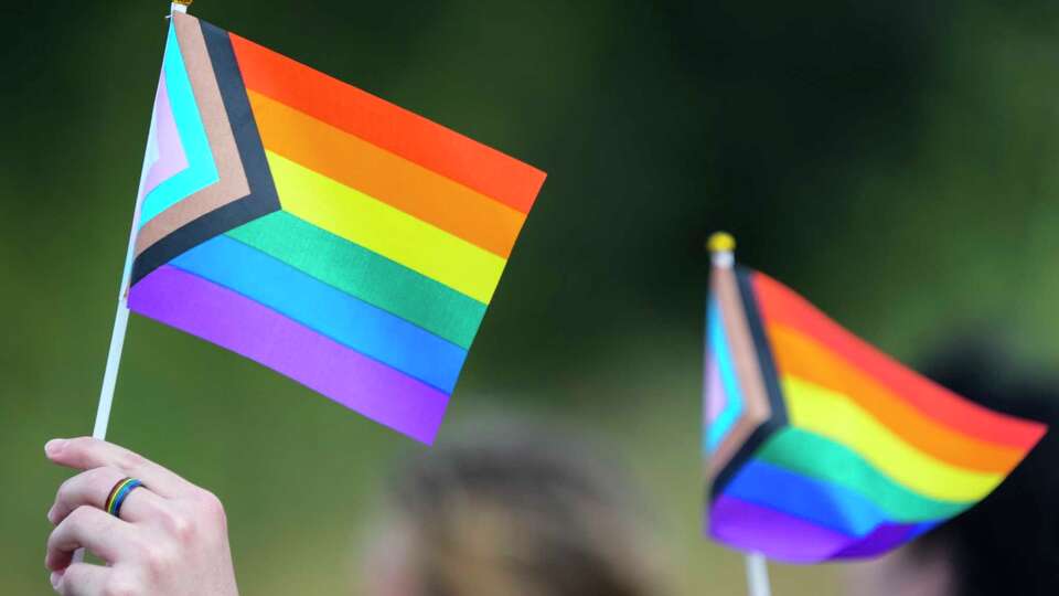 Students hold flags as they protest against Katy ISD's new transgender policy outside the school districts educational support complex on Wednesday, Aug. 30, 2023 in Katy. The students are protesting a new policy by the district where parents of students in the Katy ISD school system must be notified if their child asks to be identified as transgender under a new policy that took effect Tuesday.