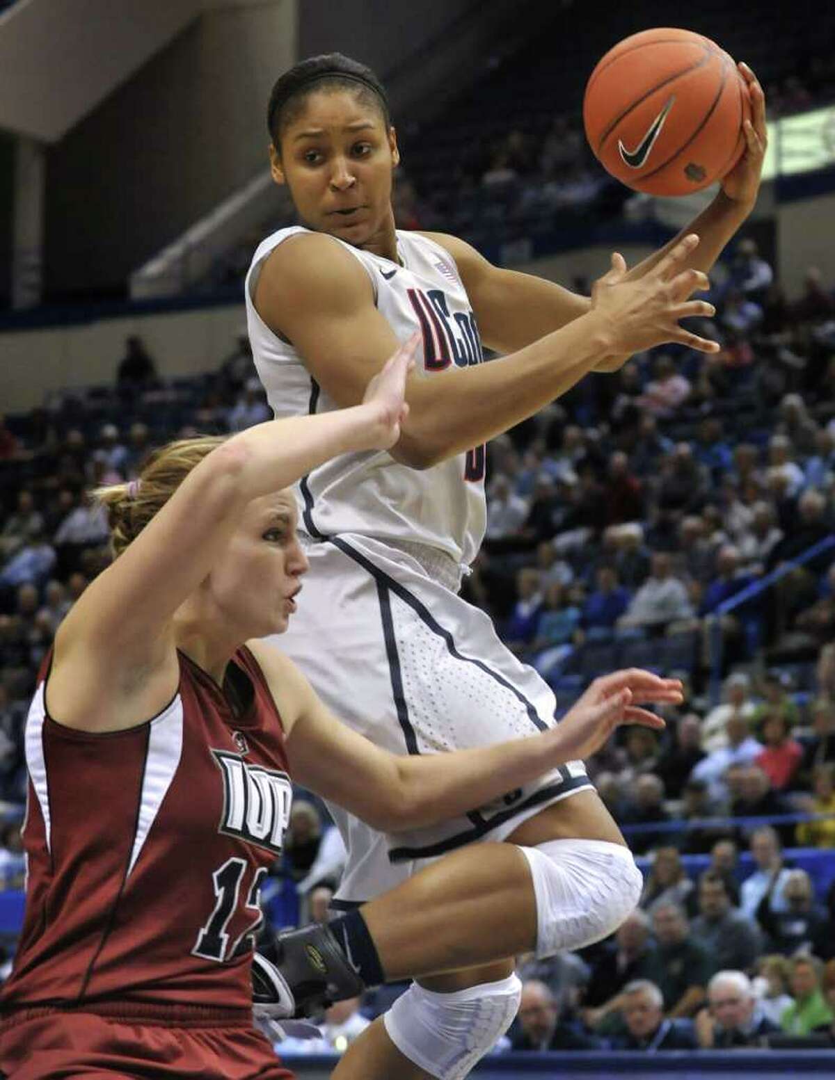 Connecticut's Maya Moore, top, drives to the basket while guarded by Indiana of Pennsylvania's Brianna Johnson during the first half of an NCAA college exhibition basketball game in Hartford, Conn., Wednesday, Nov. 10, 2010. (AP Photo/Jessica Hill)