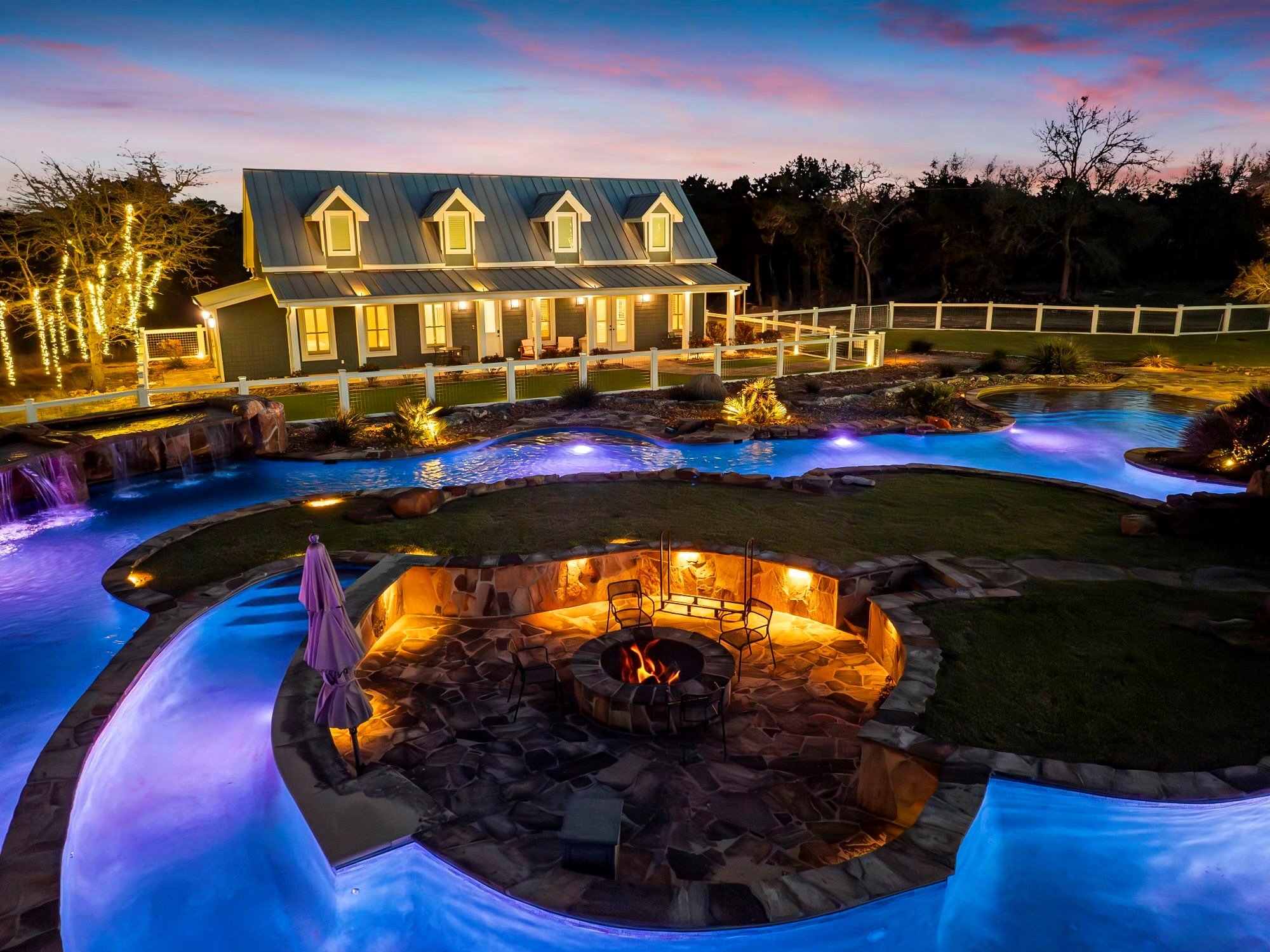 Aerial view of the illuminated lazy river and pool at Lazy River Ranch
