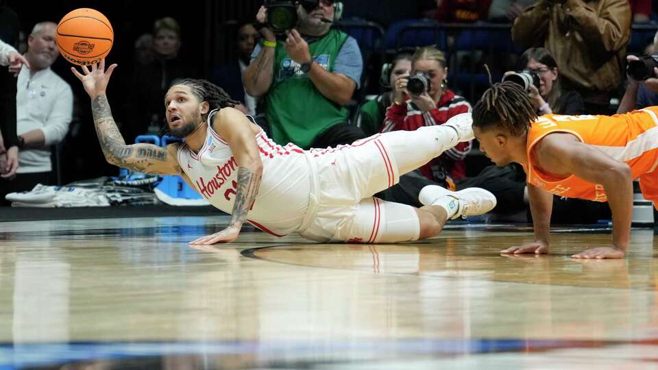 Houston guard Emanuel Sharp (21) dives for a loose ball against Tennessee guard Chaz Lanier (2) during the second half of an Elite Eight men's basketball game in the NCAA Tournament in Indianapolis, Sunday, March 30, 2025.