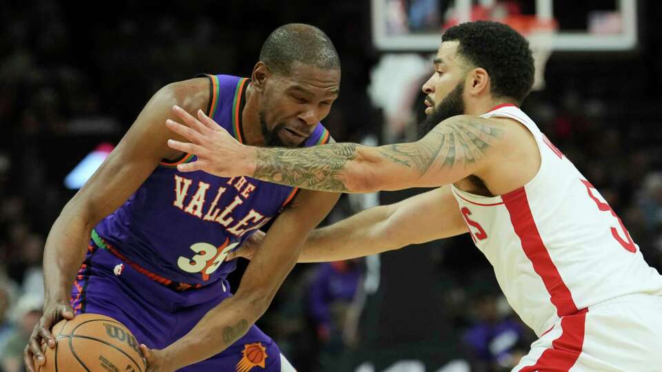 Phoenix Suns forward Kevin Durant (35) gets hit in the face by Houston Rockets guard Fred VanVleet during the first half of an NBA basketball game Sunday, March 30, 2025, in Phoenix. (AP Photo/Ross D. Franklin)