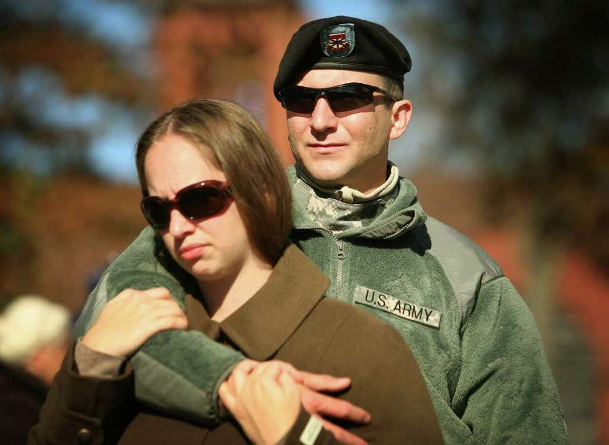 Active duty Iraq veteran Chris Jachimonski and his girlfriend Courtney Briggs, both of Derby, attend the Veteran's Day ceremony on the Derby Green on Thursday, November 11, 2010.