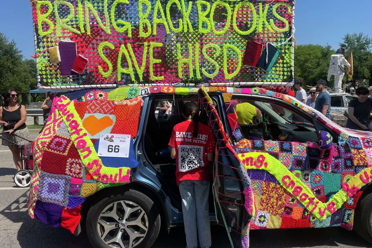 An HISD student prepares an art car made by Houston Stitching Together, an education advocacy group that hand-crochets signs protesting Houston ISD's state intervention, Saturday, April 12, 2025.