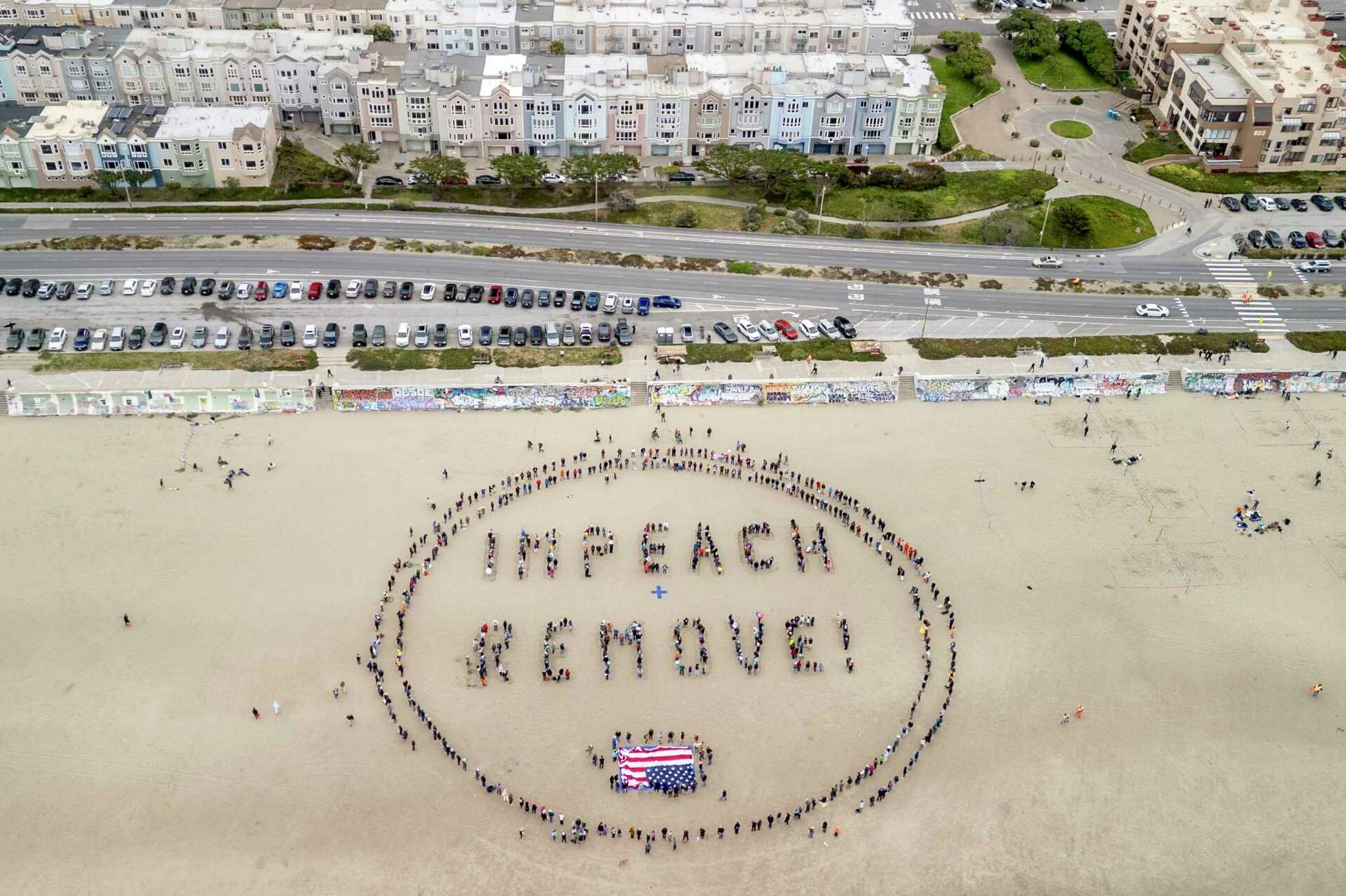 Photos: Hundreds of SF protesters form human banner to defy Trump