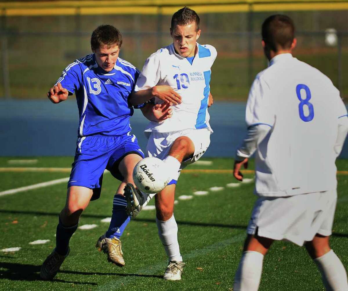 Waterford's Kyle Wells, left, battles for the ball with Bunnell's Zachary Zurita during the Bulldogs' 2-0 win in the second round of the Class L State Tournament at Bunnell High School in Stratford on Thursday, November 11, 2010.