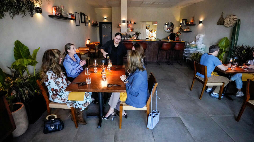 Jen Baez pours BYOB wine for guests at Tatemó in Houston.