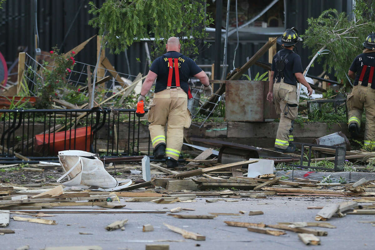 Houston Firefighters walk through the debris at Bar 5015 in Houston on Friday, June 12, 2020.