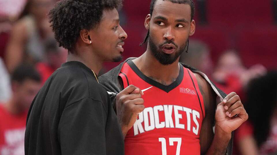 Houston Rockets forward Jae'Sean Tate (8) and forward Tari Eason (17) chat during a time out during the final minutes of game action againt the Golden State Warriors at the Toyota Center in Houston on Wednesday, April 30, 2025.