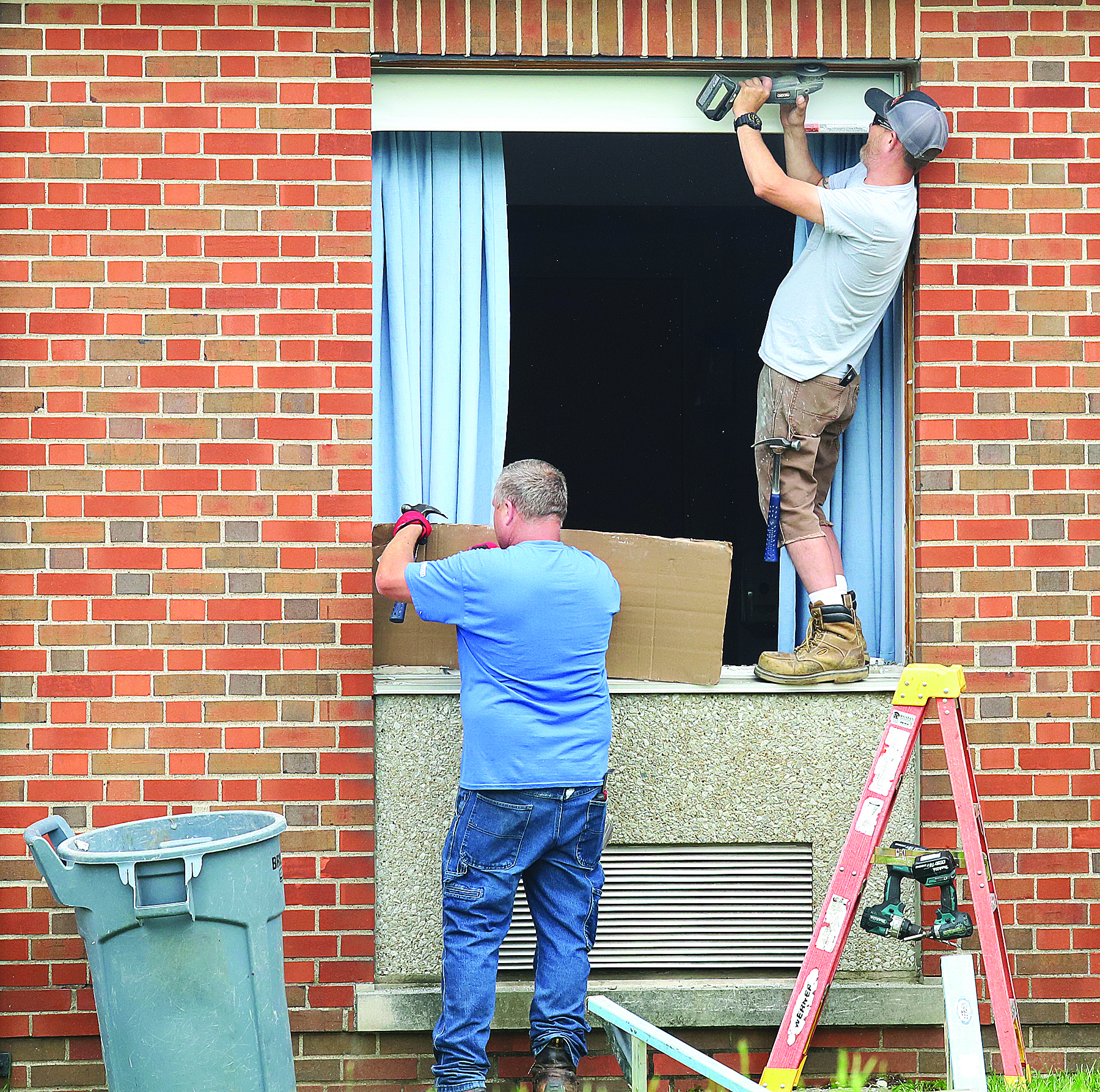 Alton Memorial window worker bends over backwards on the job