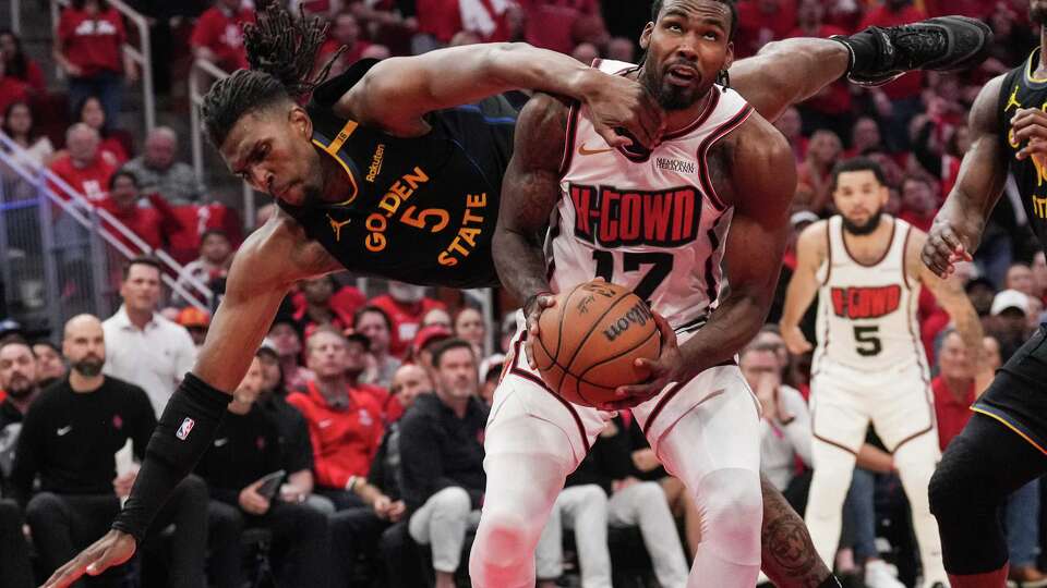 Golden State Warriors forward Kevon Looney (5) gets tangled up with Houston Rockets forward Tari Eason (17) as Eason goes up for a shot during the second half in Game 7 of a first-round NBA playoff basketball series at Toyota Center in Houston, Sunday, May 4, 2025.
