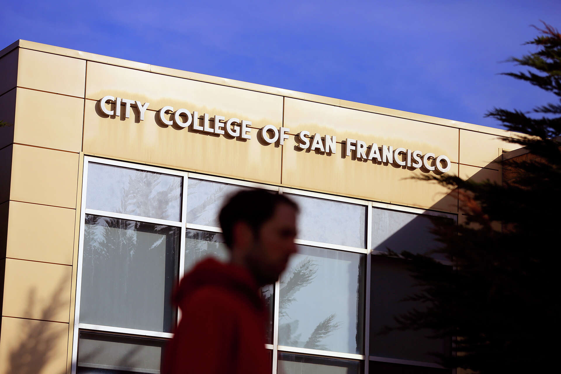 FILE: A person walks past the Student Health Center at City College of San Francisco.