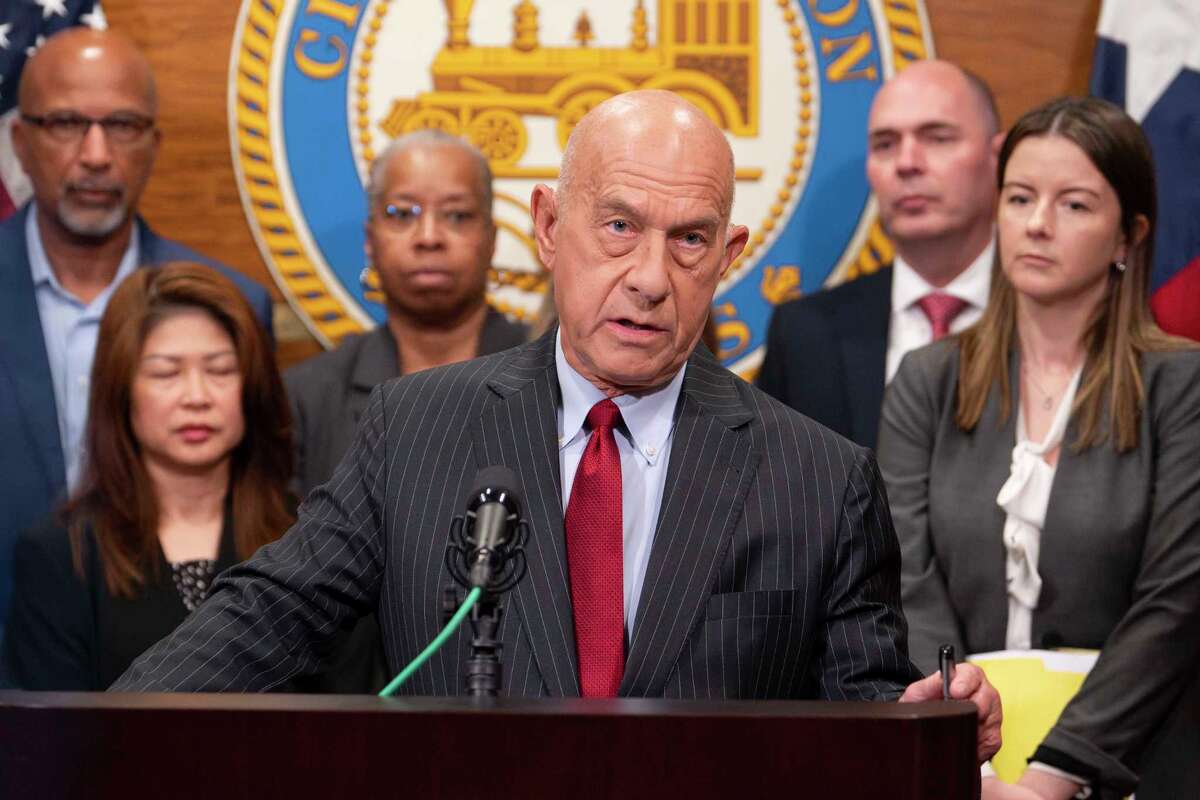 Houston city administrators and elected officials stand with Mayor John Whitmire as he discusses details of his balanced budget during a media briefing in Houston, Tuesday, May 6, 2025.