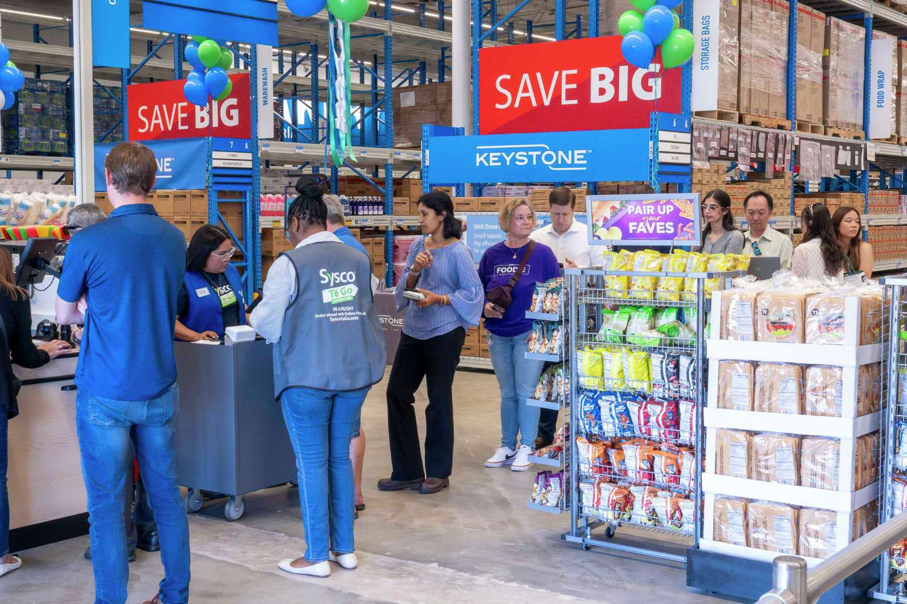 A line of customers wait to check out at the Sysco To Go A Restaurant Club location on Katy Freeway in Houston, Wednesday, May 7, 2025.
