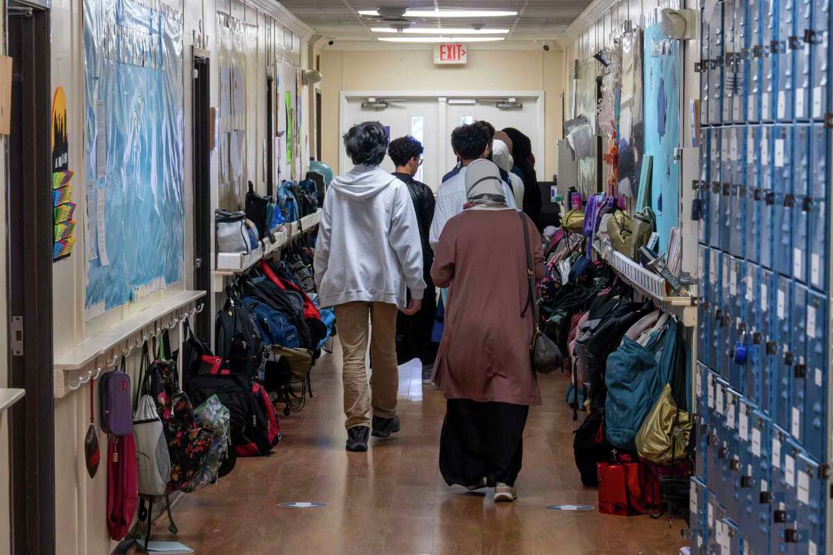 Students walk down a hallway outside classrooms at Houston Quran Academy in Houston, Friday, May 9, 2025.