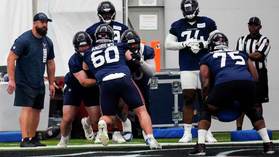 Houston Texans offensive line coach Cole Popovich, left, runs his unit in blocking drills during OTAs at Houston Methodist Training Center in Houston, Wednesday, May 28, 2025.
