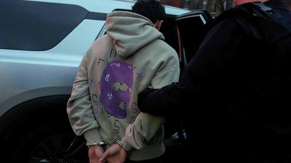 FILE - Deportation officers with Enforcement and Removal Operations in U.S. Immigration and Customs Enforcement's New York City field office arrest Wilmer Patricio Medina-Medina during an early morning operation, in the Bronx borough of New York, Dec. 17, 2024.