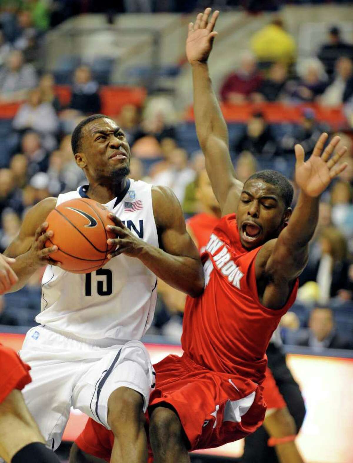Connecticut's Kemba Walker, left, drives past Stony Brook's Anthony Jackson during the first half of their NCAA college basketball game in Storrs, Conn., on Friday, Nov. 12, 2010. (AP Photo/Fred Beckham)