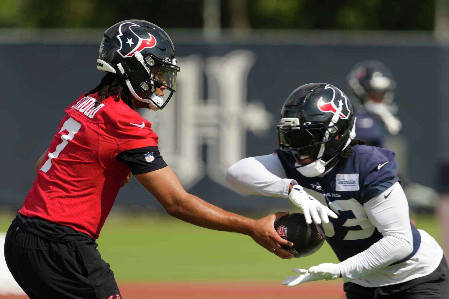 Houston Texans quarterback C.J. Stroud (7) hands the ball off to during OTAs in Houston, Tuesday, June 3, 2025.