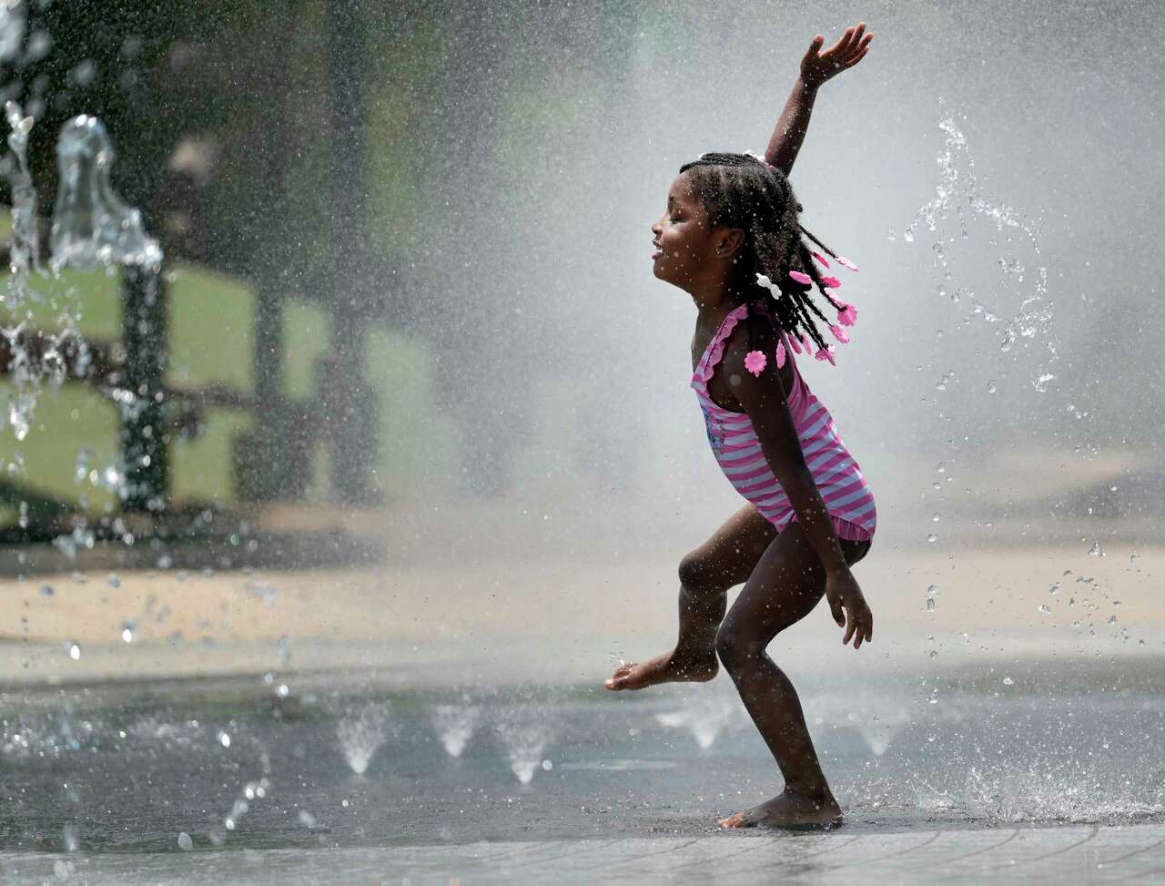 Leilani Bailey, 4, plays in the splash pad at Evelyn's Park Conservancy in Bellaire, Thursday, June 5, 2025.
