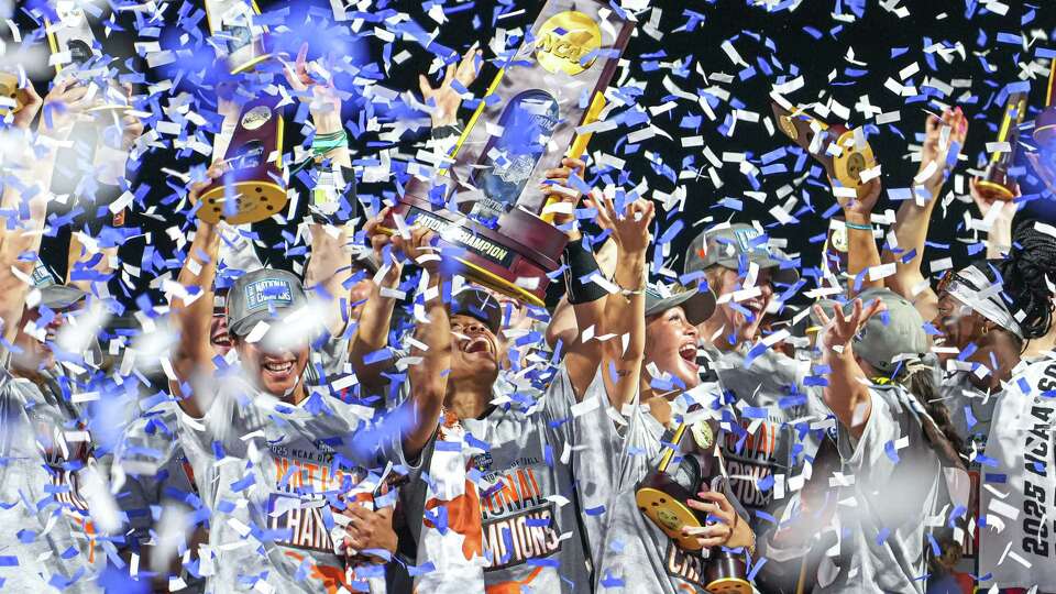 Texas Longhorns outfielder Kayden Henry (21) and the team hoist the national championship trophy after the 10-4 win over Texas Tech in game three of the NCAA Women's College World Series at Devon Park on Friday, June 6, 2025 in Oklahoma City, Oklahoma.