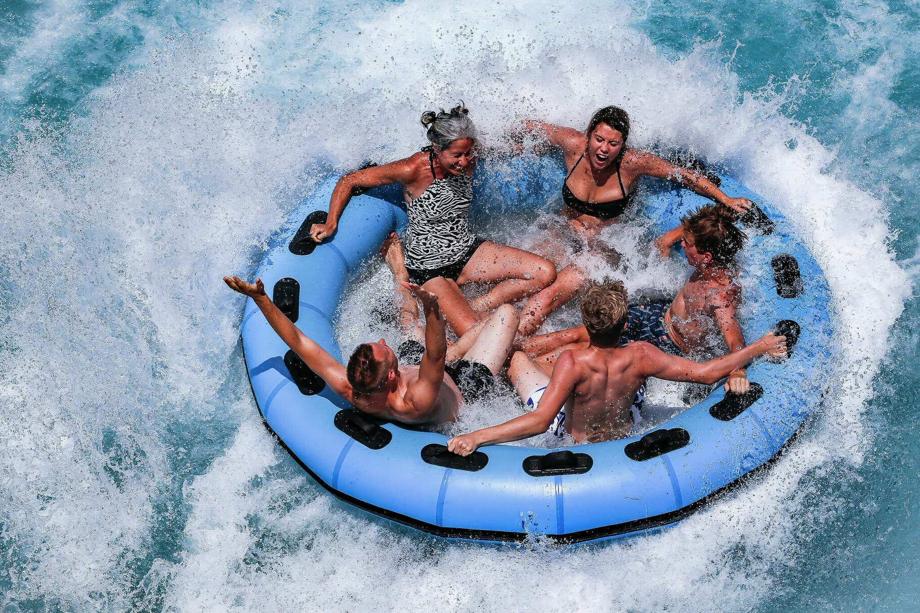 People laugh and scream as they hit the splash pool after riding The Twister at Typhoon Texas where the water park is celebrating Christmas in July all week Wednesday July 25, 2018 in Katy. (Michael Ciaglo / Houston Chronicle)