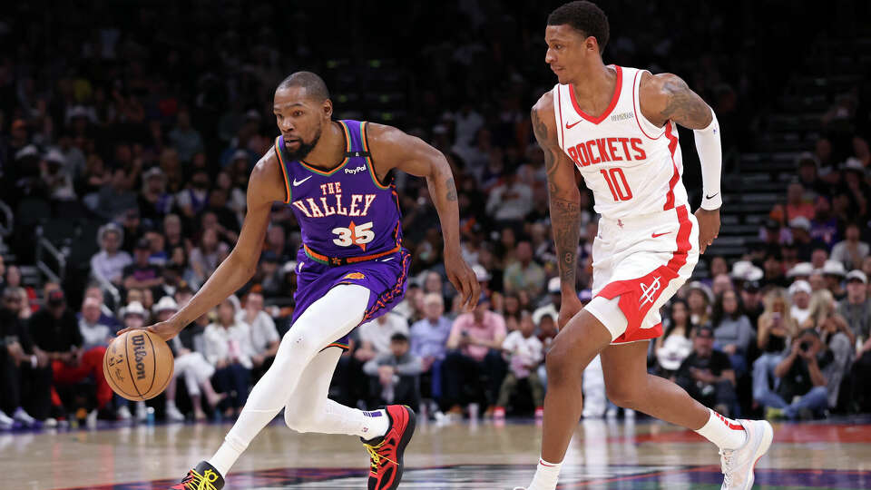 Kevin Durant of the Phoenix Suns drives to the basket against Jabari Smith Jr. #10 of the Houston Rockets during the first half at PHX Arena on March 30, 2025 in Phoenix, Arizona.