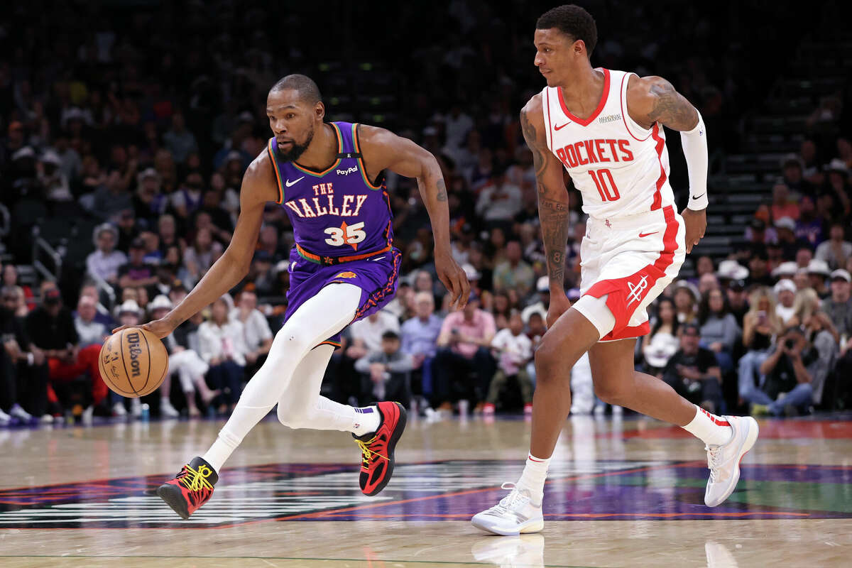 Kevin Durant of the Phoenix Suns drives to the basket against Jabari Smith Jr. #10 of the Houston Rockets during the first half at PHX Arena on March 30, 2025 in Phoenix, Arizona.