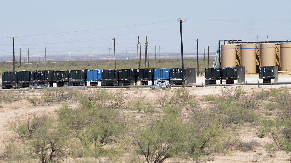 Workers clean up a well site on Wednesday, Oct. 2, 2024 in Barstow, Texas.