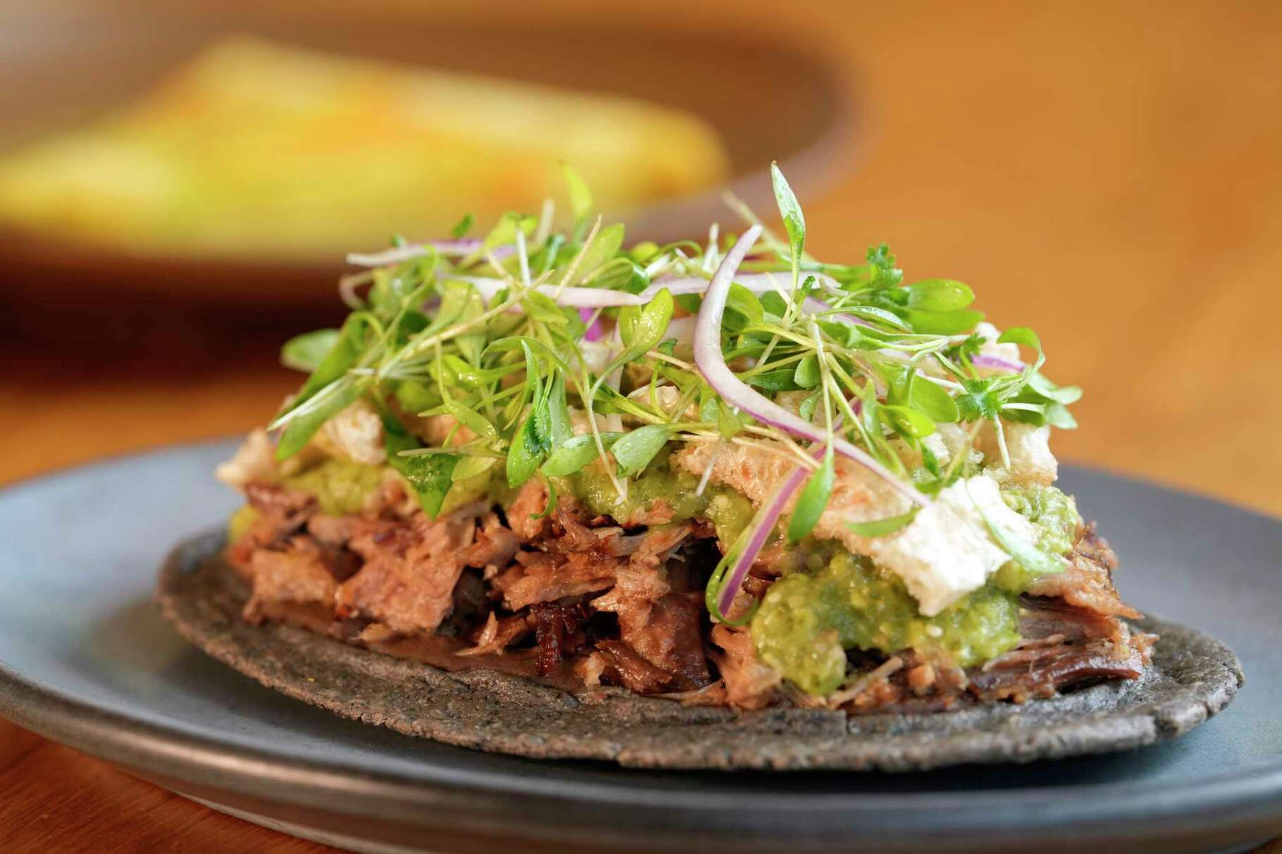 Duck carnitas huaraches is shown at Maximo in West University Place, Friday, June 20, 2025.