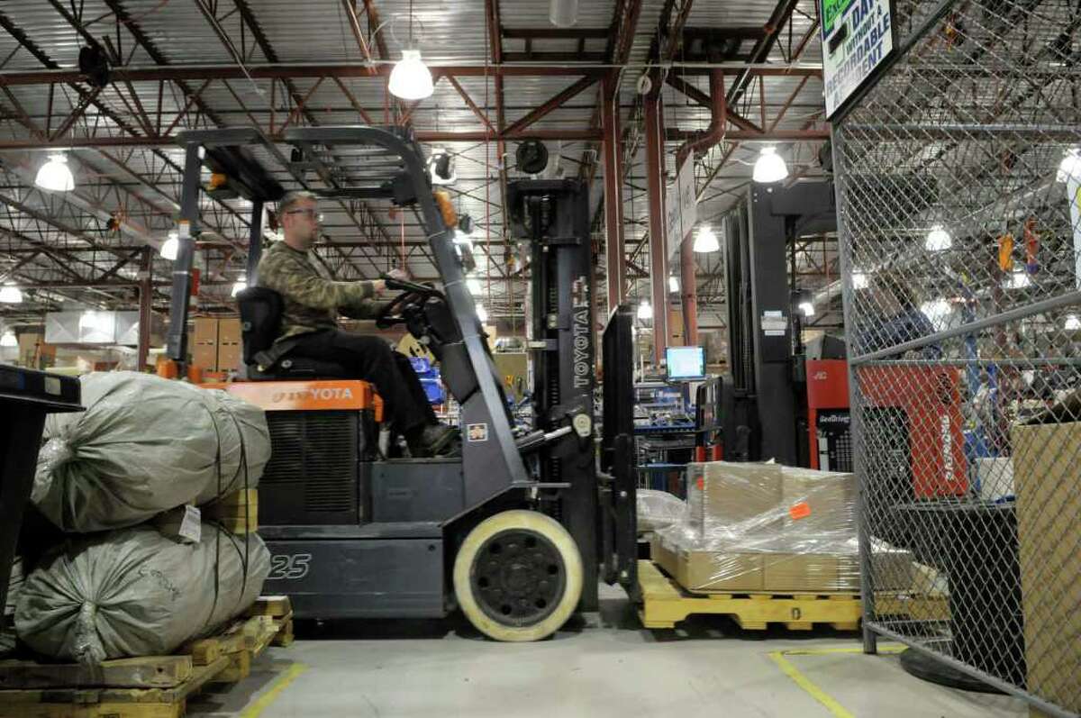 Phil Brucker, a manufacturing employee, operates a forklift powered by the company's fuel cells at Plug Power in Latham, NY on Wednesday, Nov. 10, 2010. (Paul Buckowski / Times Union)