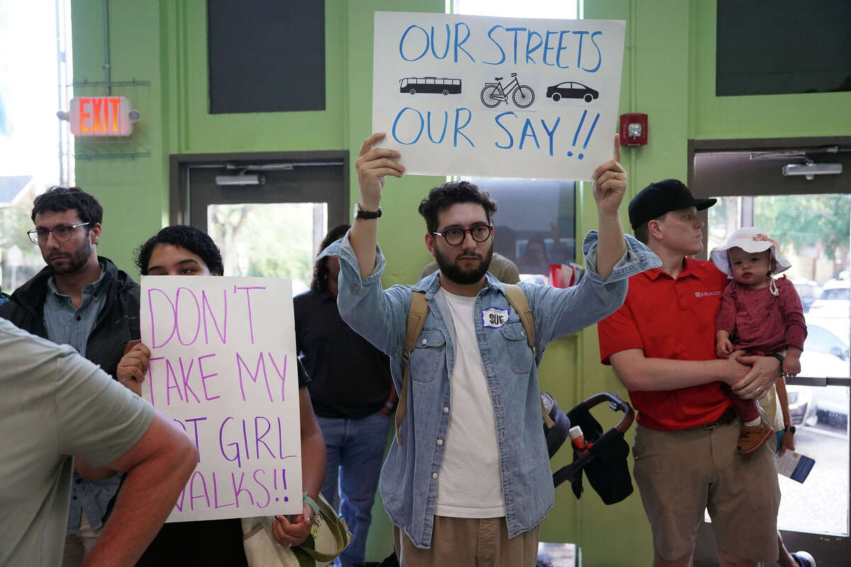 Members of Friends of the Boulevard, a group of Montrose residents advocating for a more pedestrian-friendly neighborhood, protest at St. Stephen's Episcopal Church on Monday evening during the Montrose TIRZ open house, which was held to present preliminary information on the planned reconstruction of West Alabama Street in Houston, Monday, June 23, 2025.