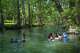 Visitors swim in Cypress Creek at Wimberley Blue Hole Regional Park on Sunday, July 30, 2023 in Wimberley, Texas.