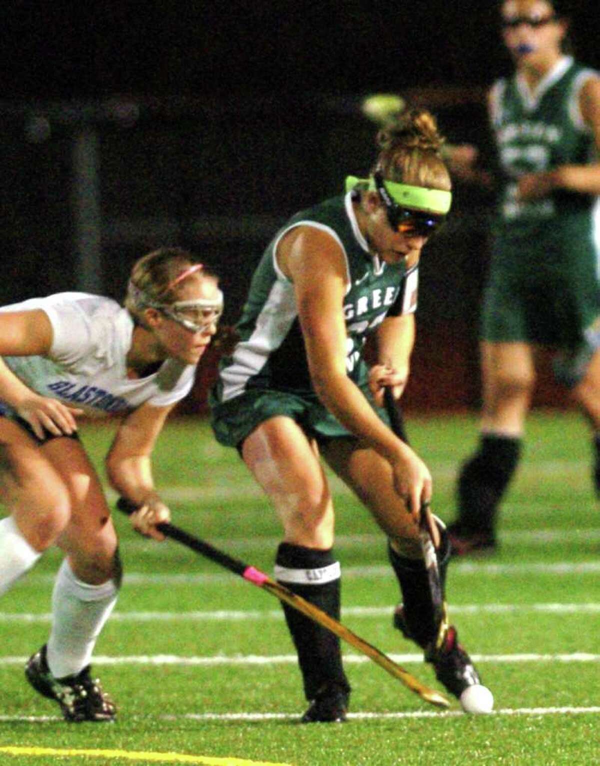 New Milford's 37, Kelsey Heaton competes with Glastonbury's 5, Hayley Hoge during the field hockey game at Watertown High School Nov. 16, 2010.