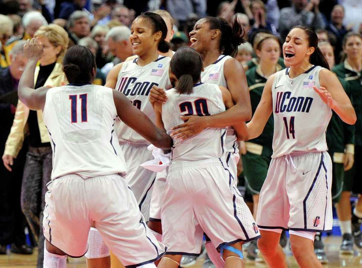 Connecticut players celebrate their 65-64 victory over Baylor in an NCAA college basketball game in Hartford, Conn., on Tuesday, Nov. 16, 2010. (AP Photo/Fred Beckham)